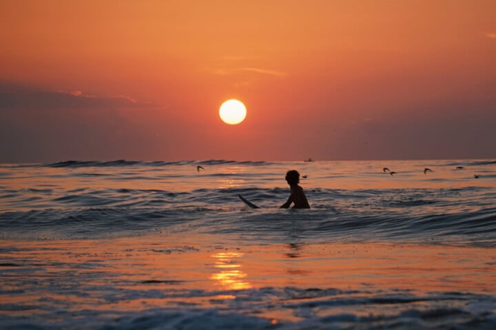 Surfing at sunset