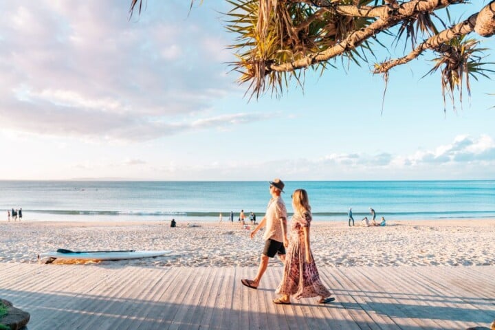 romantic couple in noosa walking from their accommodation