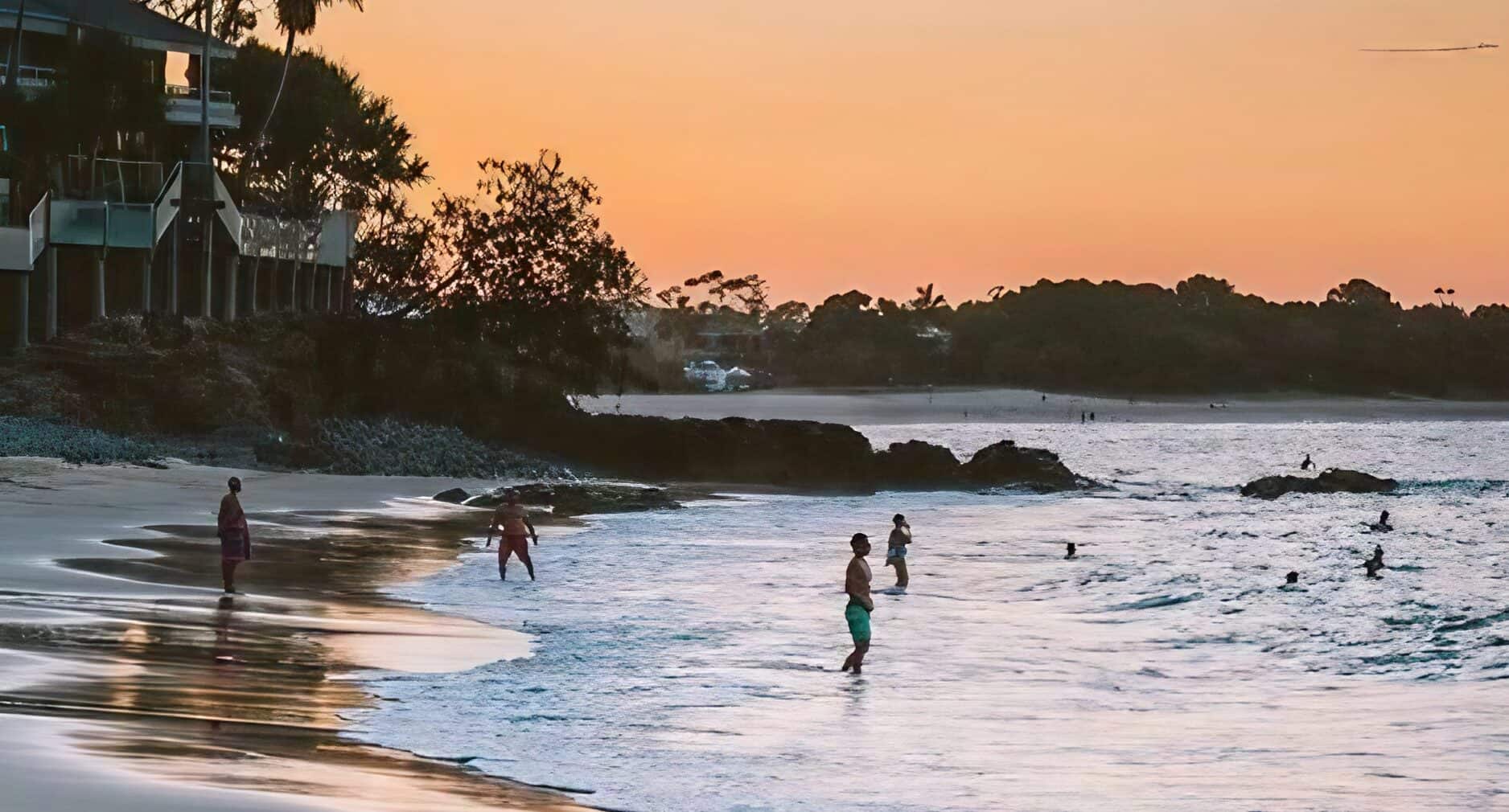 people swimming in little cove beach accommodation