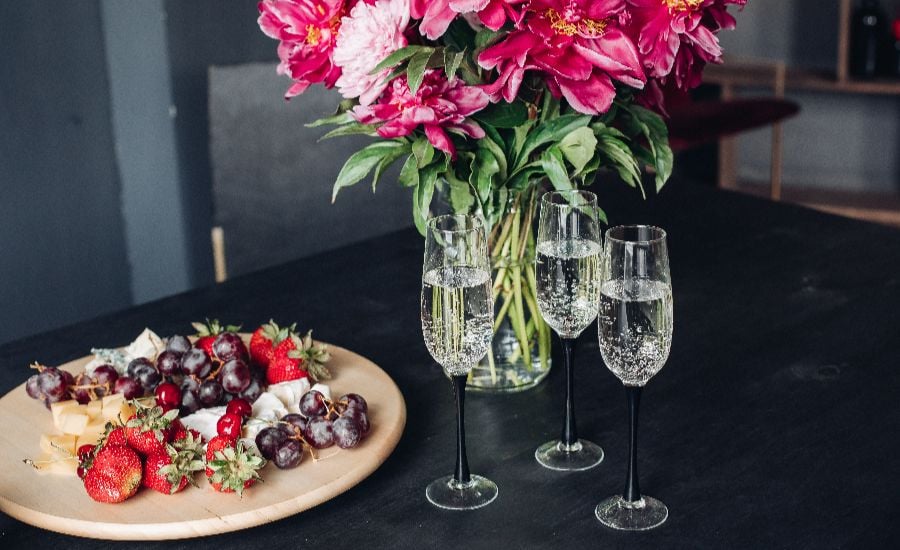 Luxury welcome platter with champagne and flowers at Noosa Beach Abodes treetop accommodation