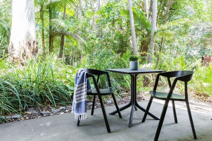 Private balcony surrounded by lush tropical greenery at Noosa treetop accommodation in Little Cove