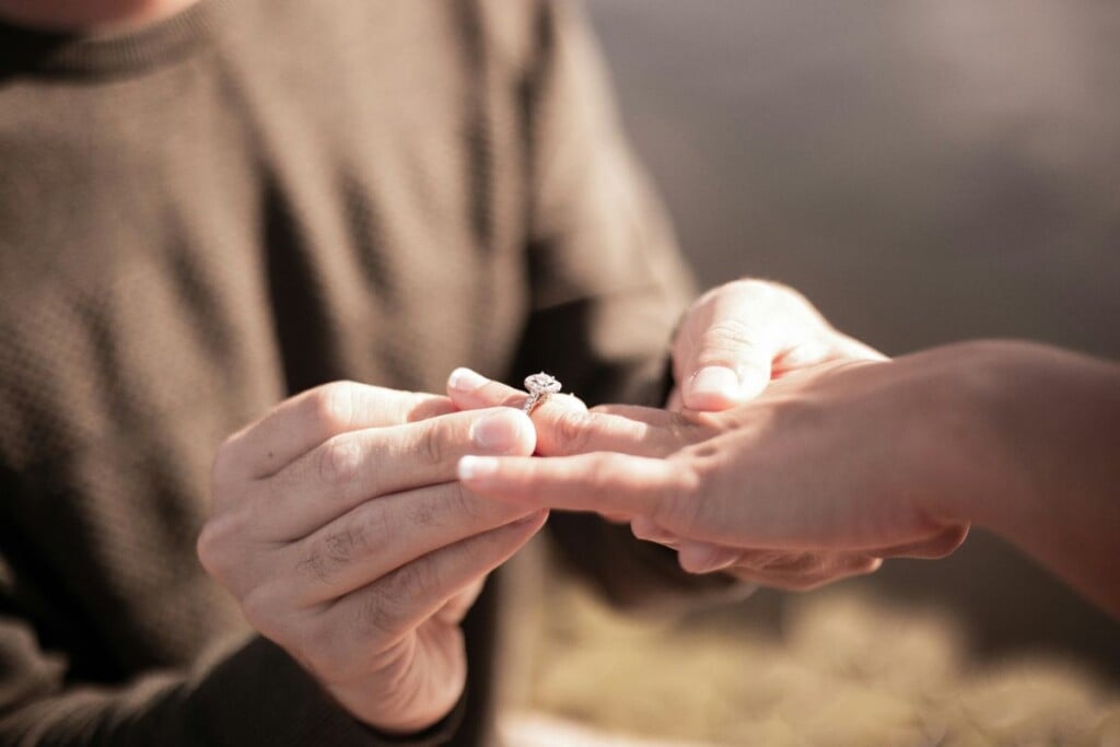 Romantic proposal in Noosa with engagement ring exchange at sunset.