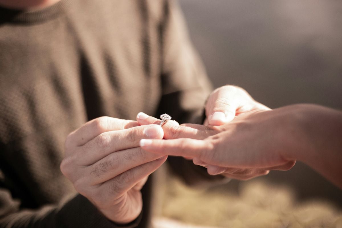 Romantic proposal in Noosa with engagement ring exchange at sunset.