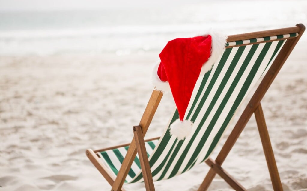 santa hat on a beach chair at noosa beach during christmas